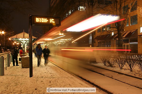 MAX Train Whizzing by, Lloyd Center, in the Snow, Night